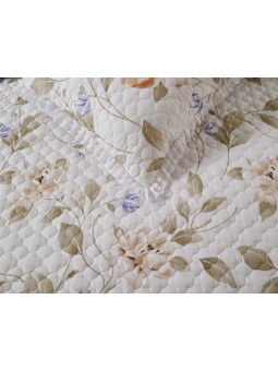 Colcha lencera con volante en tonos beige y nude.
